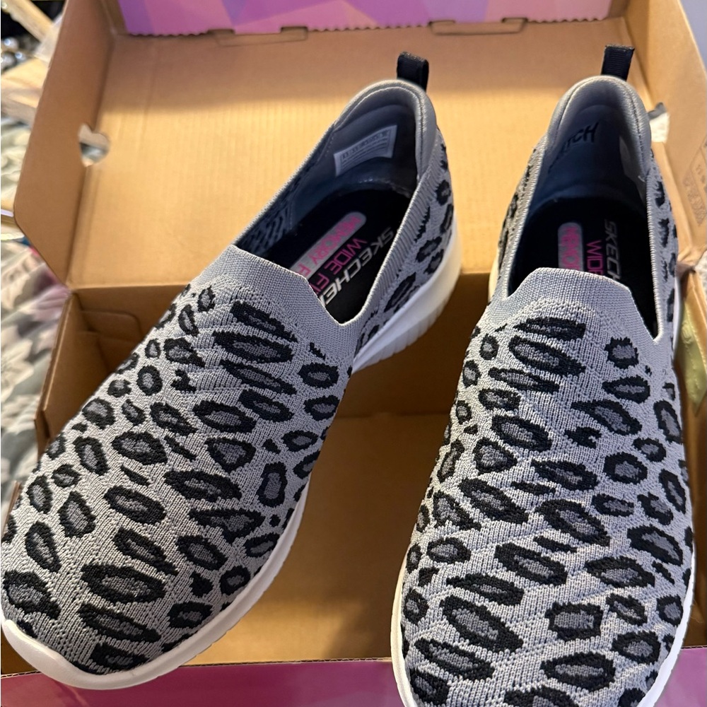 NEW IN BOX —
Skechers Women's Black and Gray Leopard Sneakers